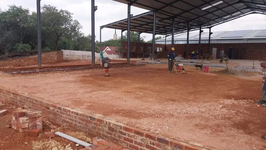 Industrial floor slab preparation within a structural steel frame