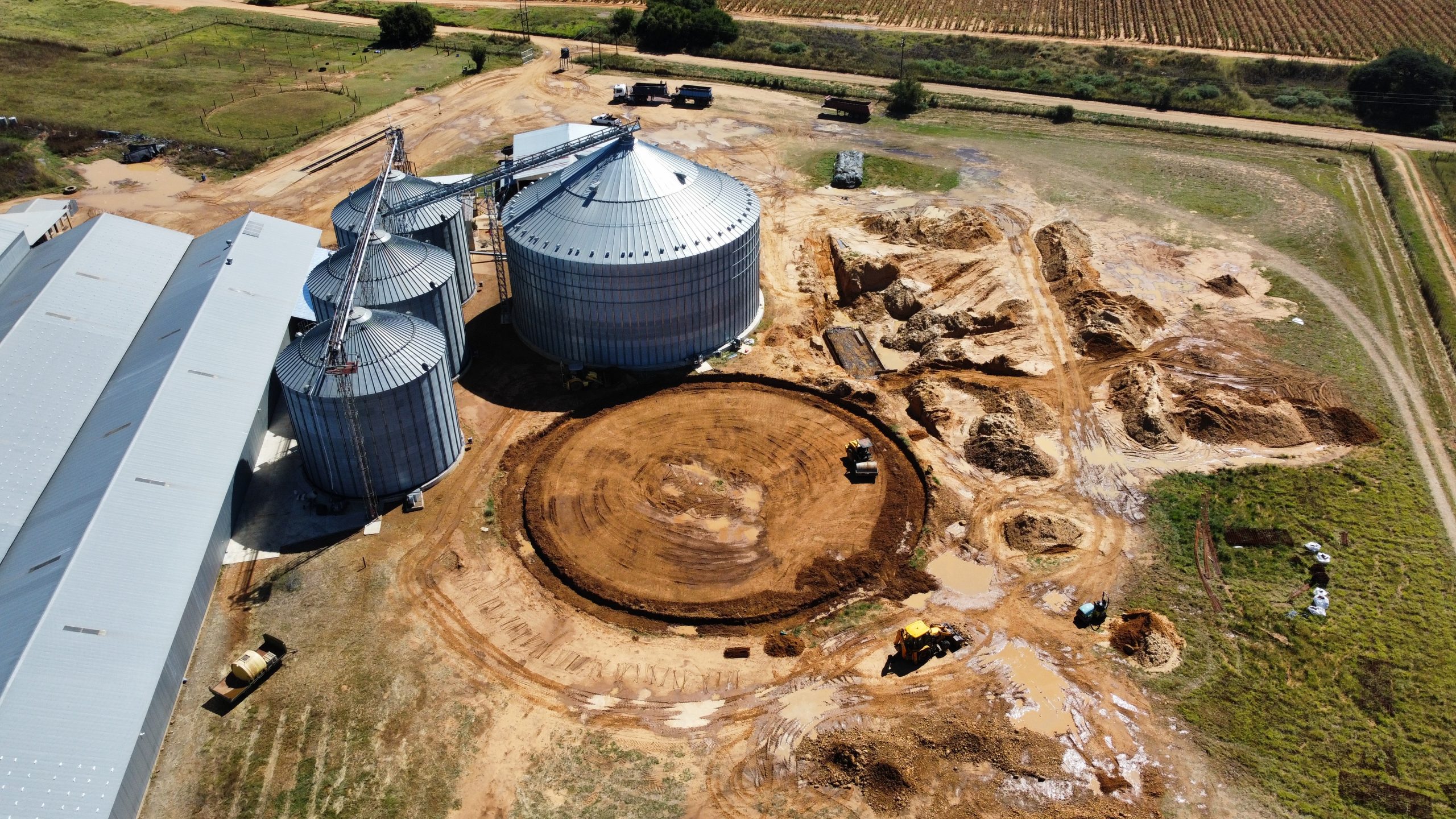 Bulk excavation and foundation preparation beside silo infrastructure